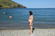   pregnant woman standing on the beach