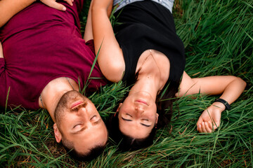 Happy couple in summer on vacation. Lovers laugh.
Happy guy and girl. Beautiful girl with long dark hair
and a young guy. Happy couple concept. Environment concept, nature