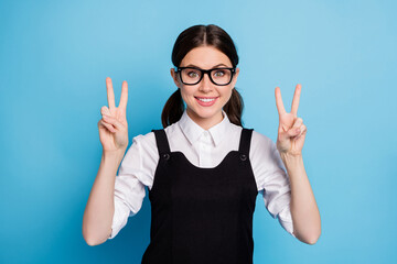 Poster - Close-up portrait of her she nice attractive pretty lovely funny optimistic cheerful cheery schoolgirl nerd geek showing double v-sign isolated bright vivid shine vibrant blue color background