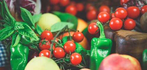 closeup of a bunch of cherry tomatoes and other fruits and vegetables - natural and healthy food concept