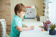 © irena_geo - Cute little boy painting with color pencils at home, in kindergaten or preschool. Creative games for kids staying at home