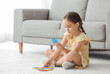 © Pixel-Shot - Little girl with autistic disorder doing puzzle at home