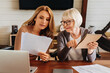 © InsideCreativeHouse - Caucasian woman explaining some documentation or bill papers to parent at home