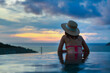 © Peera - Asian travel bikini woman relax in infinity pool on phuket beach Thailand