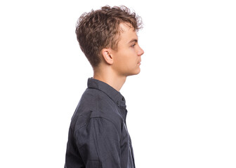 Wall Mural - Side view of portrait of teen boy in black shirt, isolated on white background. Happy child - profile. Schoolboy looking away.