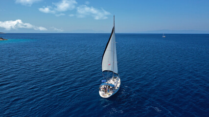 Wall Mural - Aerial drone photo of beautiful sail boat with white sails, sailing open ocean deep blue Mediterranean sea