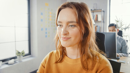 Canvas Print - Portrait Shot of Beautiful Young Female Specialist Sitting at Her Desk Working on Desktop Computer. Diverse and Modern Office with Professionals Doing their Jobs.