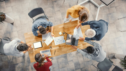 Poster - Startup Meeting Room: Team of Entrepreneurs Standing Around Conference Table Have Discussions, Solve Problems, Use Digital Tablet, Laptop, Share Documents with Statistics, Charts. Top View Shot