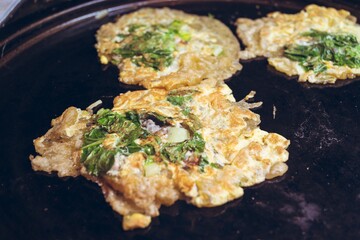 Poster - Closeup shot of traditional Taiwanese omelet in the traditional night market