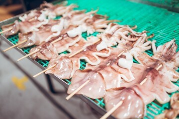 Poster - Closeup shot of squid in a barbecue at a traditional night market in Zhubei, Taiwan