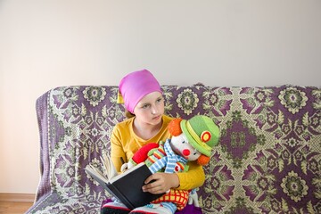 the girl reads the Bible with a toy. religious education of children. read a book at home