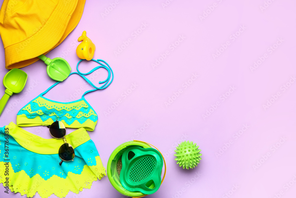 Set of beach accessories for children on color background
