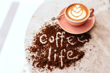 Poster - Pink cup of cappuccino on marble table background. Love latte art on the top of it.