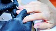 © Shenzen Photo Lab - Focus on the hands during a manicure sceance for the nails