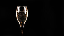 Expensive And Luxurious Vintage Champagne With Delicate Bubbles In A Wine Glass On A Black Background