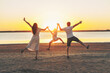 © Nikita - Young parents with son jumping on the sunset on the beach.
