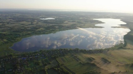 Wall Mural - Drone shot on summer lake at dawn. Aerial view of summer landscape lake. 
