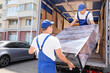 © Pixel-Shot - Loaders taking furniture from truck