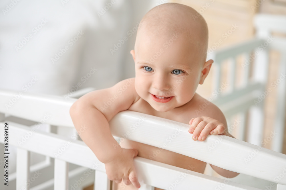 Cute little baby in bed at home