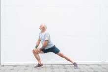 Senior Man Stretching Legs Before Workout