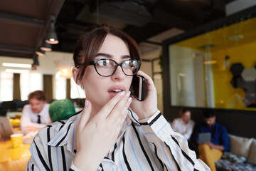 Poster - portrait of businesswoman with glasses using mobile phone