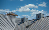 Fototapeta Miasta - Ribbed Metal Roof Under Blue Skies
