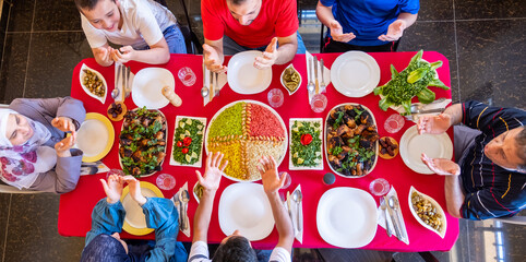 Happy arabic muslim family praying to god prior eating and asking