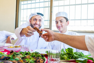 Wall Mural - Arabic Muslim family eating together in a meeting for iftar in Ramadan