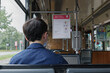 © Peeradontax - Interior and selected focus view at the back of asian male passenger with face protection mask who sit in light rail tram or train in Germany during epidemic of COVID-19 virus with new normal concept.