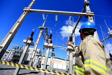 lauro de freitas, bahia / brazil - august 10, 2016: technician observes wiring in a Coelba substation in the Itinga neighborhood in the city of Lauro de Freitas. 