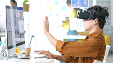 VR application test, Asian man with virtual reality glasses headset touching air during the VR experience, Asia male developers with virtual reality simulator application, ux, ui test