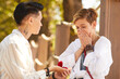 © AnnaStills - Woman proposing to her happy girlfriend outdoors love and marriage concept