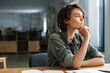 © Drobot Dean - Image of woman thinking and writing down notes while sitting at table