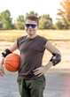 © Alina - Active teenager boy smiling in sun glasses enjoying outdoor games with an orange ball.  Sport. Basketball. Hobby, active lifestyle.