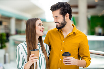 Poster - Close-up portrait of his he her she nice attractive lovely charming cheerful cheery couple embracing spending weekend day drinking latte walking urban visiting commercial building indoors