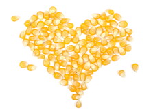 Corn Kernels, Popcorn Pile Arranged In Romantic Heart Shape Isolated On White Background, Top View