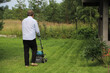 © iritetereva - A man mows the grass on his own cottage plot