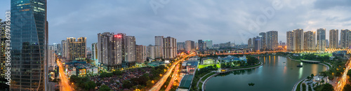 Fototapeta na szkło Cityscape of Hanoi skyline at Thanh Xuan park during sunset time in Hanoi city, Vietnam