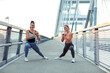 © pucko_ns - Two fit body shape girl exercise outdoor at the bridge to stay in good condition