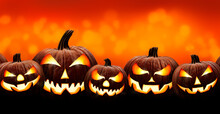 Five Halloween, Jack O Lanterns, With Evil Spooky Eyes And Faces Isolated Against A Orange And Yellow Lit Background.