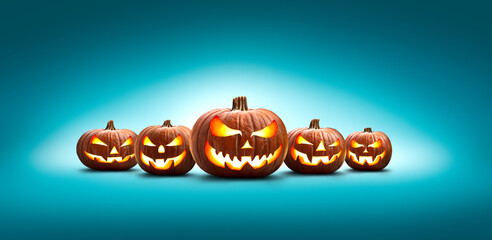 Wall Mural - five halloween, jack o lanterns, with evil spooky eyes and faces isolated against a blue lit backgro