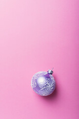 Wall Mural - Christmas violet ball on the pink background