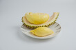 Durian in a plate on a white background and clipping path. Durian is a Thai fruit that is delicious and has a pleasant aroma.