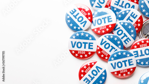 Pile of patriotic voting buttons on white background
