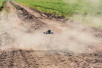 Sticker - Racing drone flying over green field