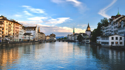 Switzerland: Zurich river Limmat landscape at sunset, view on the old buildings of the city