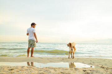 A man and a dog on the beach.