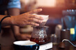 © Charnchai saeheng - Barista measuring coffee drip with glass mug