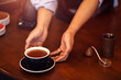 © Charnchai saeheng - Barista serving cup of coffee on the table