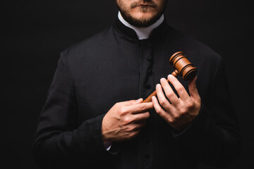 Sticker - cropped view of bearded priest holding wooden gavel isolated on black